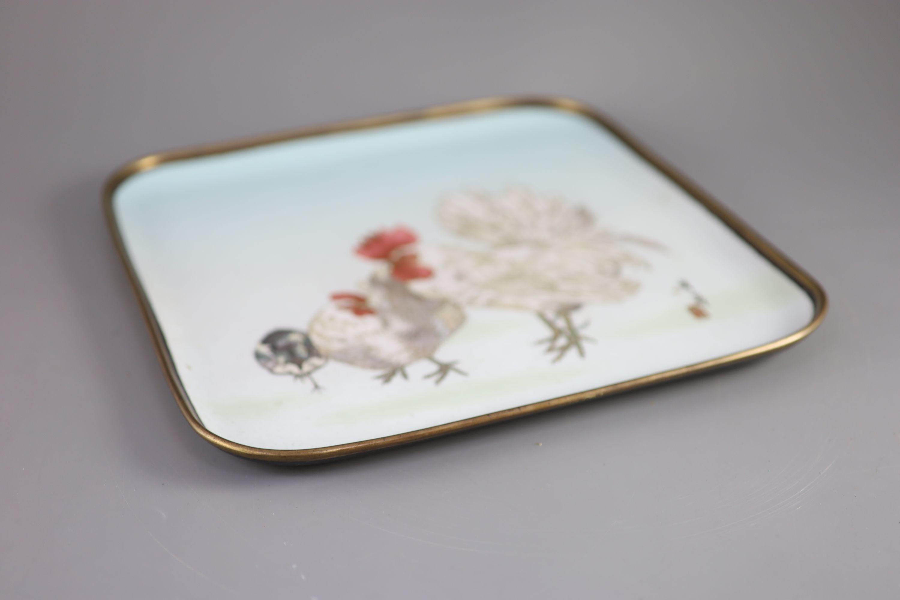 A Japanese square cloisonne tray, Meiji period, decorated with cockerel, hen and chick on a pale blue ground, Deakin Bros & Co, Japan